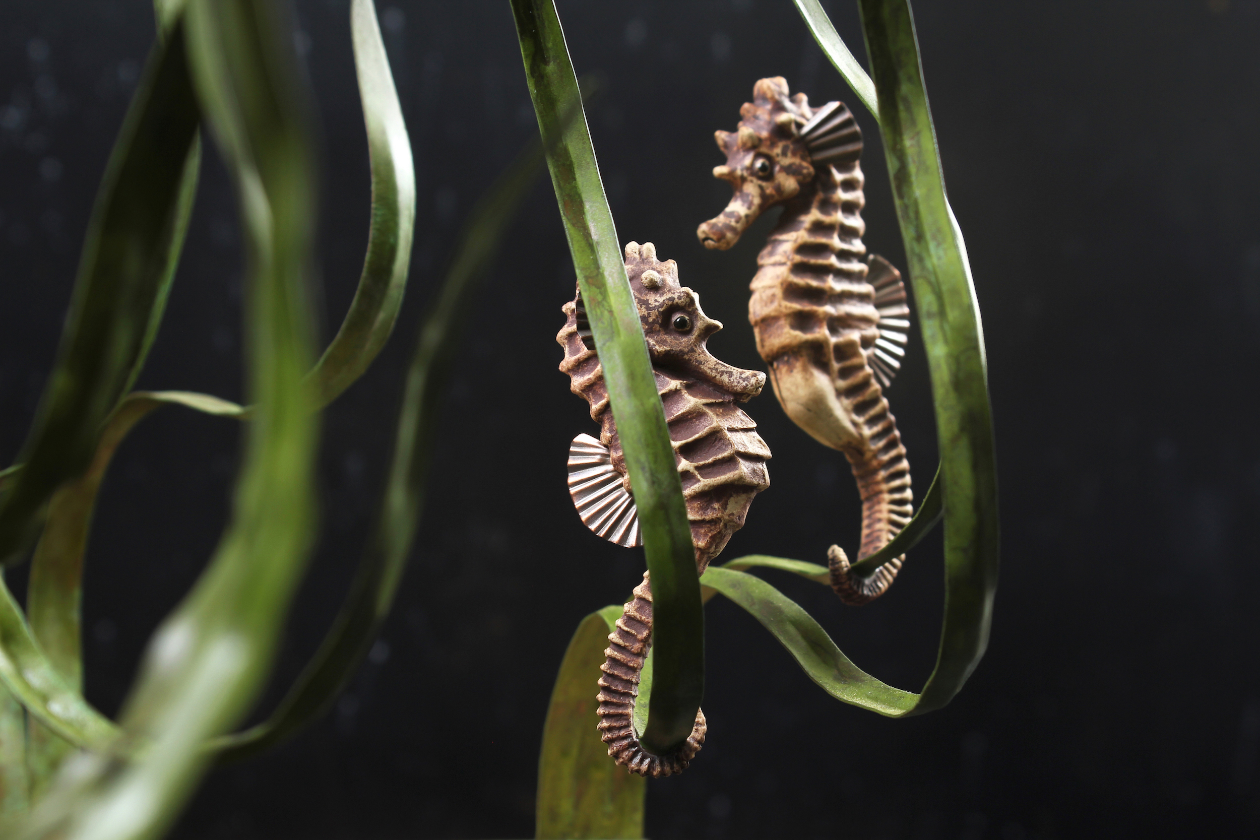Seahorses in stoneware ceramic with beaten copper fins mounted on patinated copper seagrass